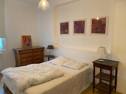 une chambre avec un lit, une commode et une table dans l'établissement Les Sarcelles Hardelot Plage, à Neufchâtel-Hardelot