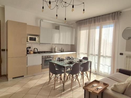 a kitchen and dining room with a table and chairs at La Meridiana 12 in Trecate