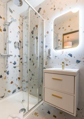 a bathroom with a shower and a sink and a mirror at Luxury Eleven Bedroom House Sleeps 23 5-10 mins walk from town Centre in Killarney