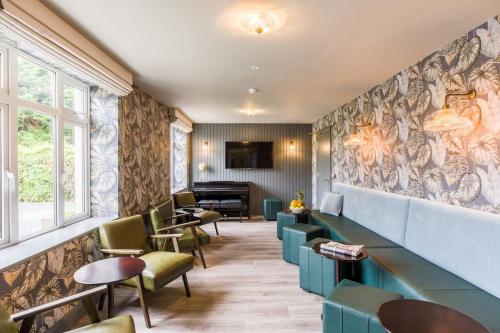 a waiting room with chairs and a piano at Luxury Eleven Bedroom House Sleeps 23 5-10 mins walk from town Centre in Killarney
