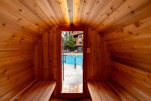 an inside of a wooden sauna with a mirror at The Eagle Suite at Stoneridge Mountain Resort in Canmore