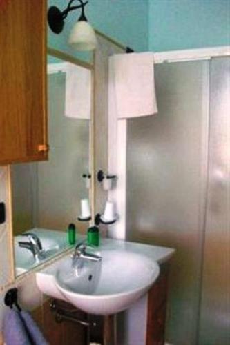a bathroom with a sink and a mirror at Tra... Monti E Vigne in La Morra