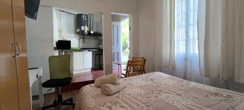 a bedroom with a bed with a towel on it at Comarca Valparaíso in Valparaíso