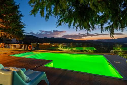 a green pool on the deck of a house at Casa Avó Chiquinha in Montalegre