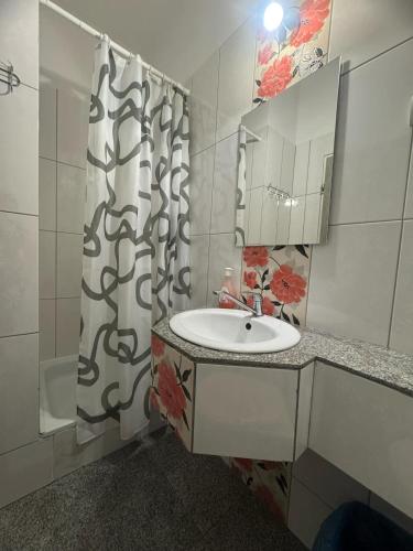 a bathroom with a sink and a shower curtain at OŚRODEK WYPOCZYNKOWY MAZOWSZE W KARPACZ in Karpacz