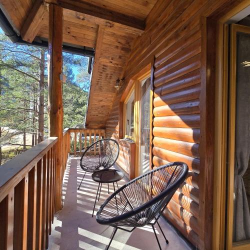 two chairs sitting on a porch of a cabin at Trebevićki Raj 1 in Brus