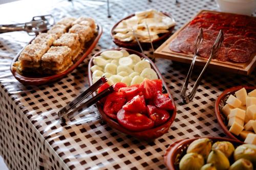 a table topped with bowls of fruit and other desserts at Elite Rooms Kolasin in Kolašin