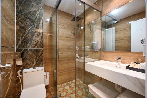 a bathroom with a toilet and a sink and a shower at Ly Ly Hotel 2 Binh Tan District in Ho Chi Minh City