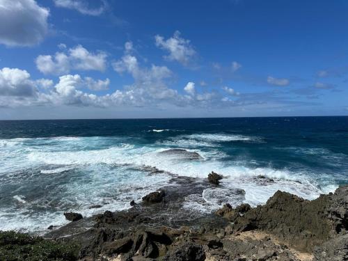 a view of the ocean from a rocky beach at Residence Ville Noire in Mahébourg