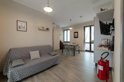a living room with a couch and a table at Casa Rubbo - Appartamento in collina 'Monviso' in Alba