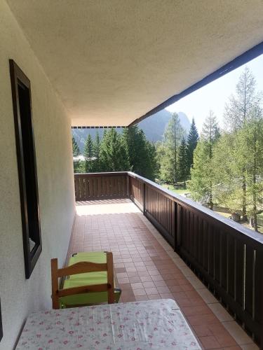 a balcony with a table and chairs and a view at Appartamento a Sella Nevea Casa Susanna in Sella Nevea