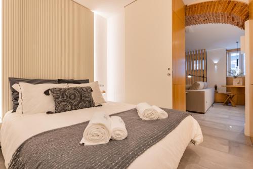 a bedroom with a large bed with towels on it at Condessa Heaven RC in Lisbon