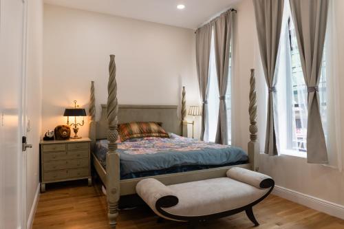a bedroom with a bed and a chair and a window at Little manhattan near Time Square in New York