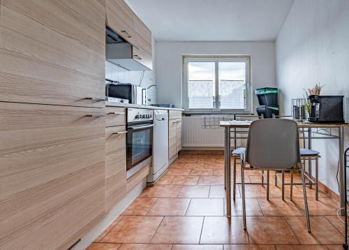 a kitchen with a table and chairs in a room at Pension Bärbel Neelen in Hameln