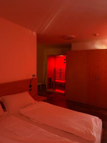 a bedroom with a bed and a red light at Ski Lodge Pampeago in Tesero
