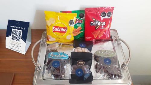 a tray with food and other snacks on a table at GALA Hotel Boutique in Guadalajara