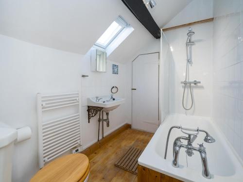 a bathroom with a sink and a bath tub at Pass the Keys Cosy cottage hideaway set in beautiful countryside in Hopesay