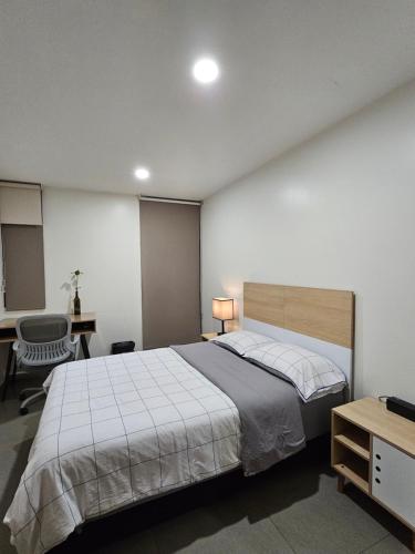 een slaapkamer met een groot bed en een bureau bij NSI Alameda Park Humboldt Mexico City in Mexico-Stad