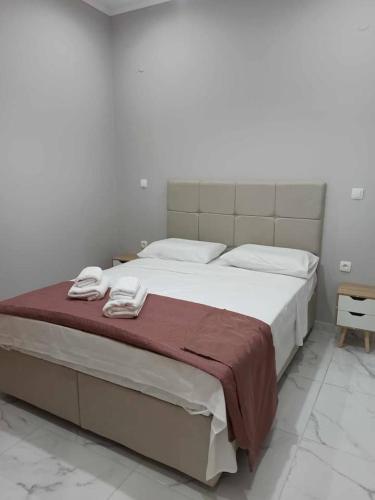 a bedroom with a large bed with two towels on it at Chios Cozy Apartment 1 in Sklaviá
