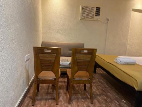 Ένα ή περισσότερα κρεβάτια σε δωμάτιο στο Mumbai Residency