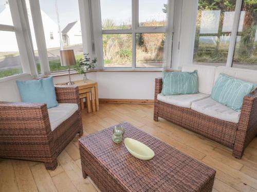 a living room with two chairs and a table at Horn Head View in Carrigart