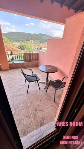 a balcony with a table and two chairs and a table at Xenonas Arxontariki in Mikrón Dhérion