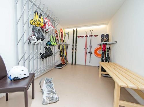 a room with skis and ski equipment on a wall at Appartement Haus Sonne in Zell am See