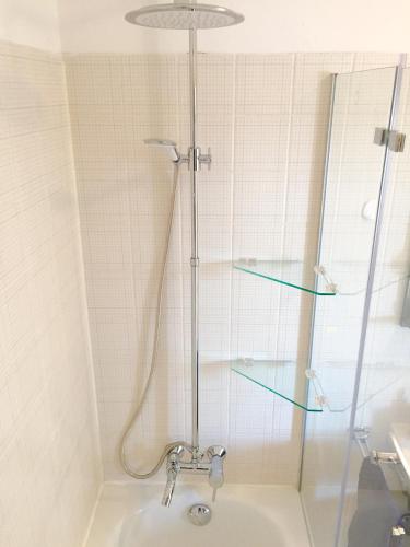 a shower with a glass door in a bathroom at Central Studio with mini balcony in Weigelshof