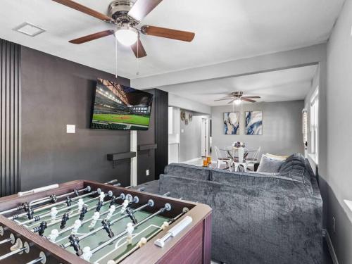 a living room with a foosball table and a couch at Casa Noa in Euless