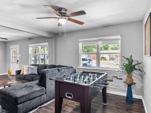 a living room with a couch and a table with a chessboard at Casa Noa in Euless