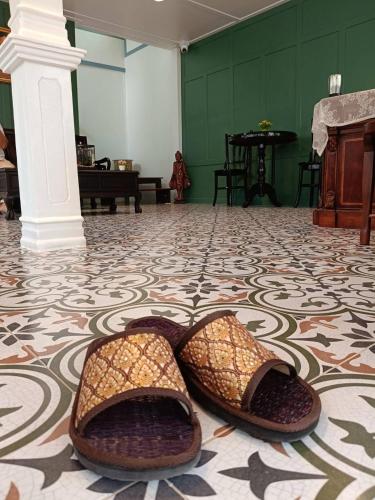 a pair of shoes sitting on the floor of a room at Baan Debtida in Bangkok