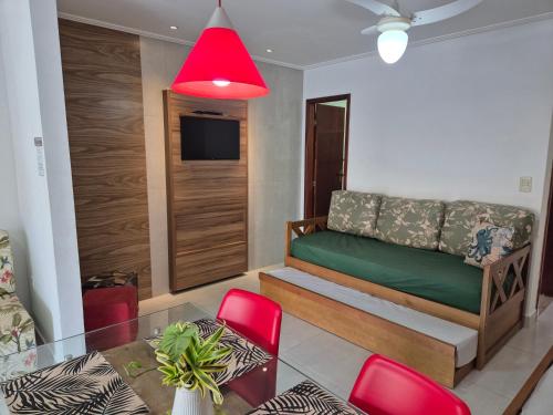 a living room with a couch and a glass table at Mar Y Suites in Cabo Frio