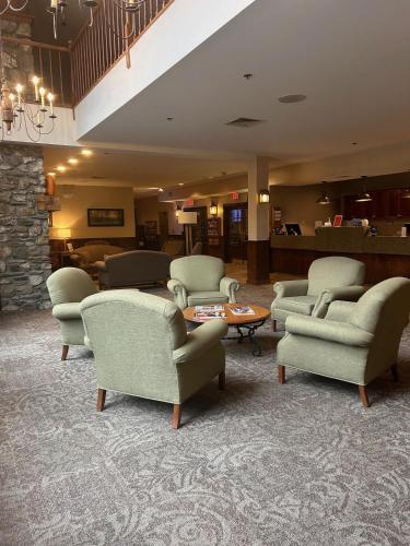 a waiting room with chairs and a table and a lobby at Jiminy Peak Mountain Resort in Hancock