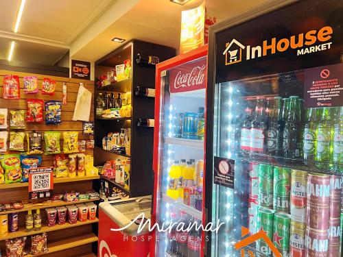 a refrigerator in a store with a lot of drinks at Move - Tambaú in Tambaú