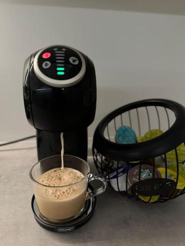 a coffee maker is making a cup of coffee at Gabiežezers Holiday House, 30km from Riga in Cena
