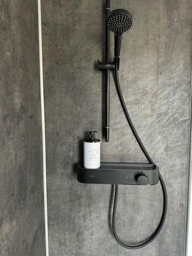 a shower with a blow dryer on a wall at Gabiežezers Holiday House, 30km from Riga in Cena