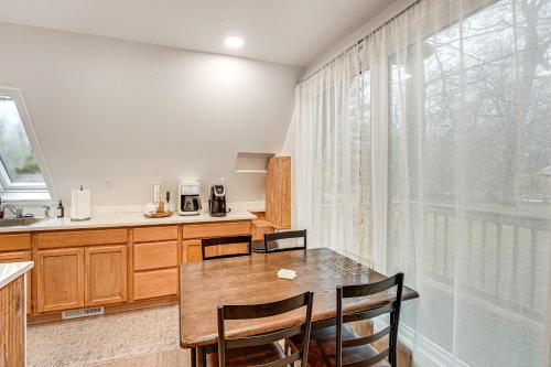 a kitchen with a table and chairs and a window at Walk to Fox Lake Pet-Friendly A-Frame with Fire Pit in Twin Lake