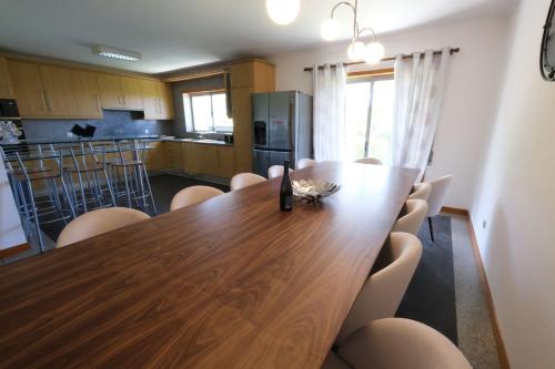a dining room with a wooden table and chairs at high standard rental in a quality residence with pool, tennis and view of the ocean in antas esposende 12 people in Esposende