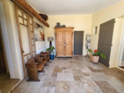 a hallway with a wooden door and some stairs at Air-conditioned villa with heated pool, Luberon, in Puget - 10 people in Puget