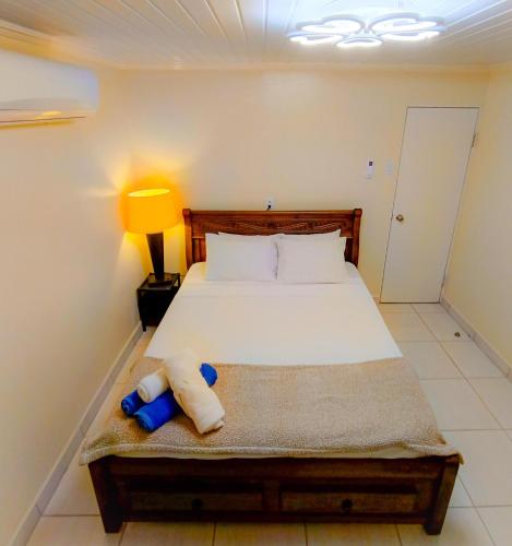 a bedroom with a bed with a stuffed animal on it at Elite Visitors Aruba in Oranjestad