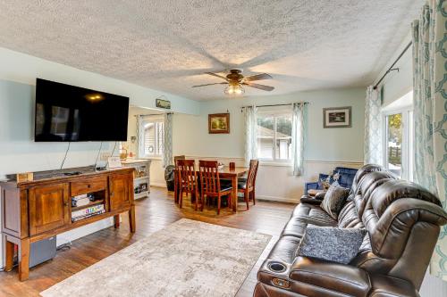 a living room with a couch and a flat screen tv at Walk to Sandusky Bay Home with Hot Tub and Fire Pit! in Sandusky