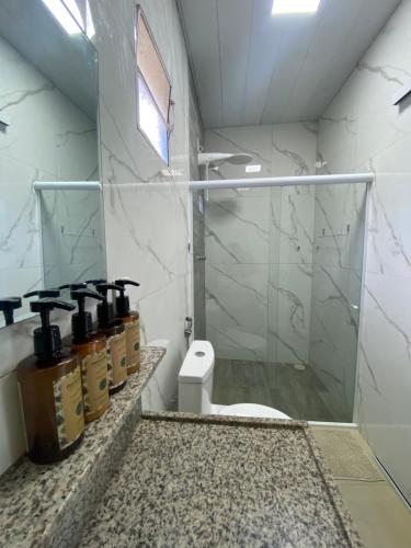 a bathroom with a toilet and a glass shower at Pousada do Nativo in Fernando de Noronha