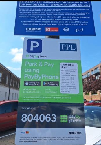 a sign for parking and pay using pay phone at Executive Waterfront Split Penthouse in Woolwich