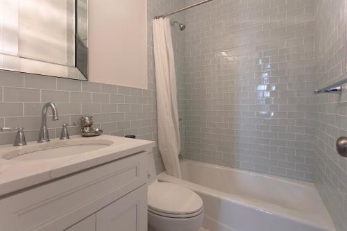 a bathroom with a sink and a toilet and a shower at Little manhattan near Time Square in New York