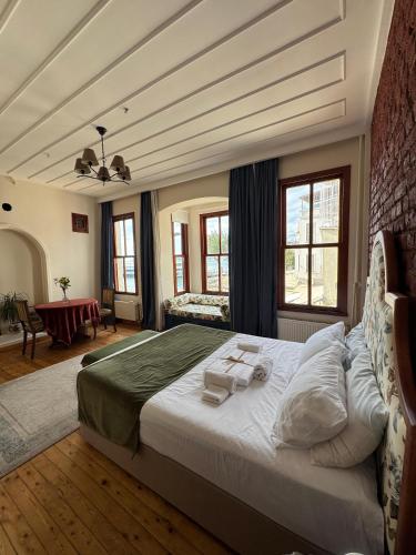 a bedroom with a large bed with towels on it at Levant Company Pension de Luxe in Istanbul