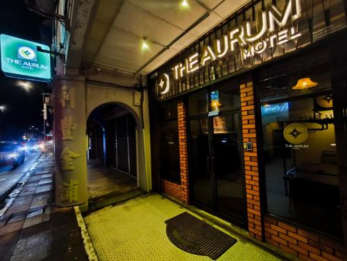 an empty sidewalk in front of a restaurant at night at The Aurum Motel - self check-in - in Alor Setar