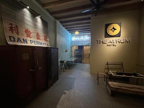 a room with a sign on the wall and a table at The Aurum Motel - self check-in - in Alor Setar