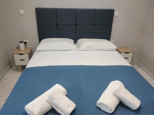 a bedroom with a bed with two towels on it at Chios Cozy Apartment 2 in Sklaviá