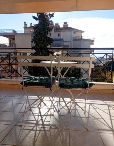 a white table sitting on top of a balcony at Siame in Drama