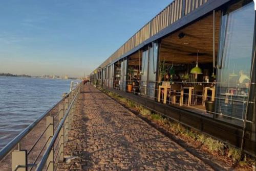 a building next to a body of water at Espaço inteiro no Centro Histórico, bem localizado in Porto Alegre